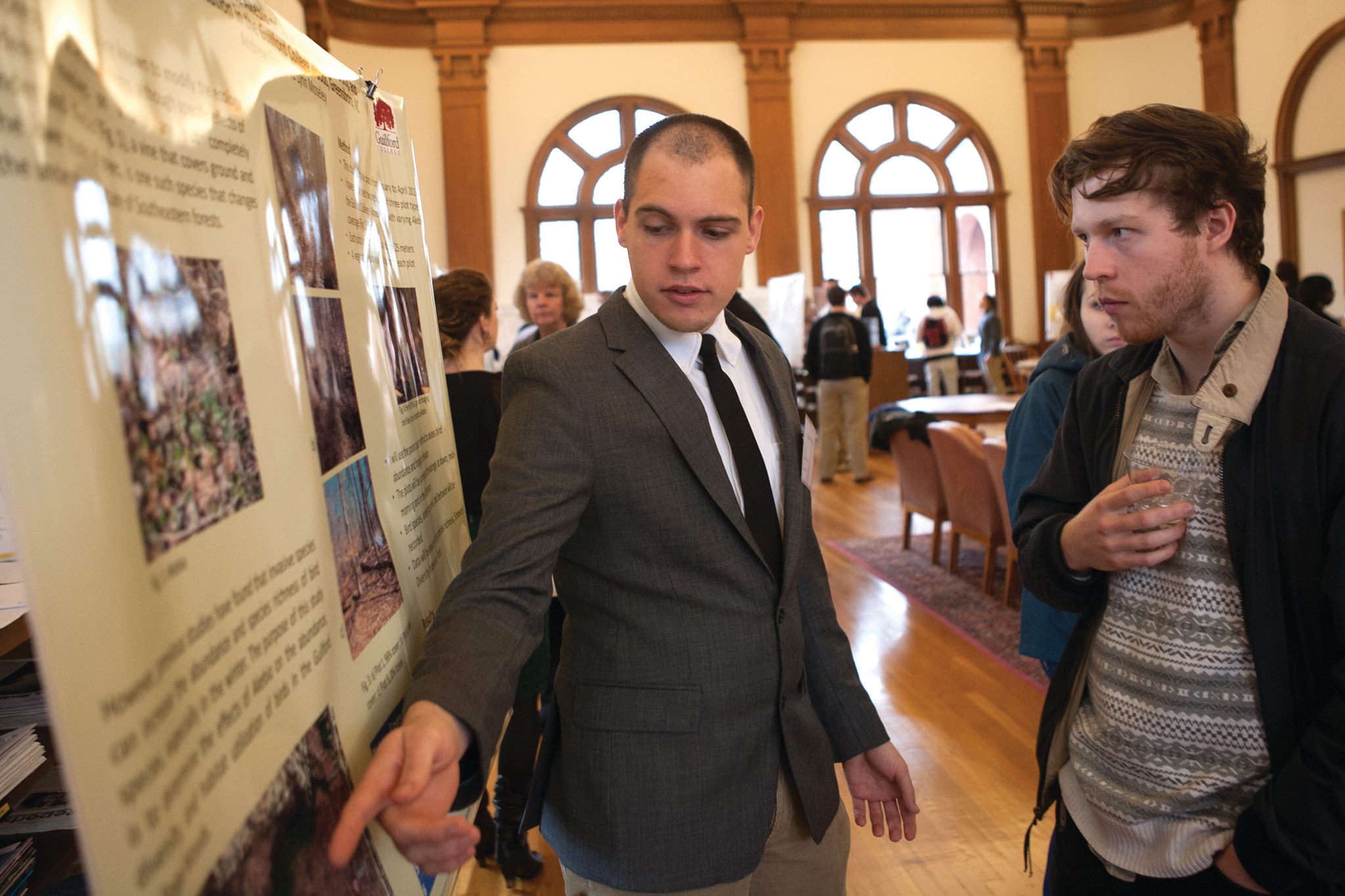 A student presenting a poster at GUS 2022